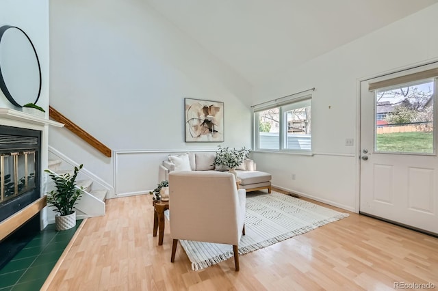 494 Owl Dr Unit 4, Louisville, CO 80027 - dining area with wood finished floors, stairway, vaulted ceiling, a glass covered fireplace, and baseboards