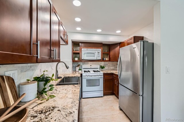 494 Owl Dr Unit 4, Louisville, CO 80027 - kitchen with white appliances, a sink, light stone counters, tasteful backsplash, and open shelves