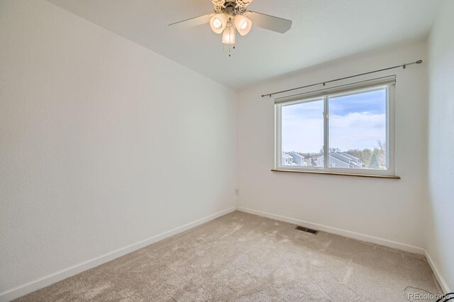 494 Owl Dr Unit 4, Louisville, CO 80027 - spare room featuring light carpet, baseboards, and a ceiling fan