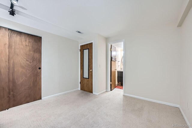 494 Owl Dr Unit 4, Louisville, CO 80027 - unfurnished bedroom featuring light colored carpet, baseboards, and ensuite bathroom