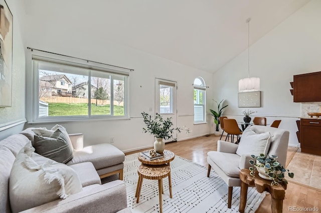 494 Owl Dr Unit 4, Louisville, CO 80027 - living area featuring high vaulted ceiling, light wood finished floors, and baseboards