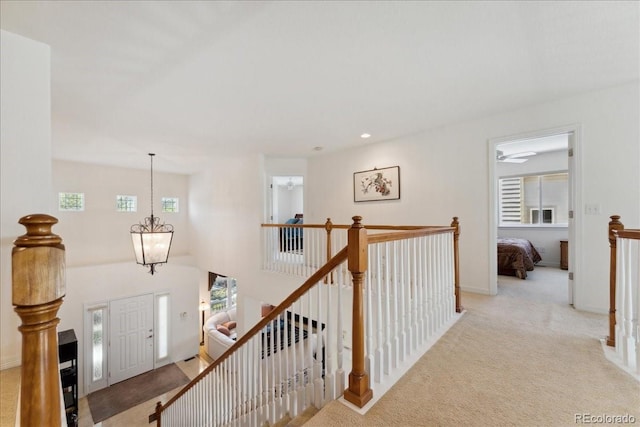7132 S Tempe Ct, Aurora, CO 80016 - hall with an upstairs landing, carpet, a chandelier, and recessed lighting