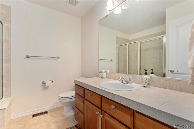 7132 S Tempe Ct, Aurora, CO 80016 - bathroom featuring vanity, toilet, a stall shower, tile patterned flooring, and baseboards