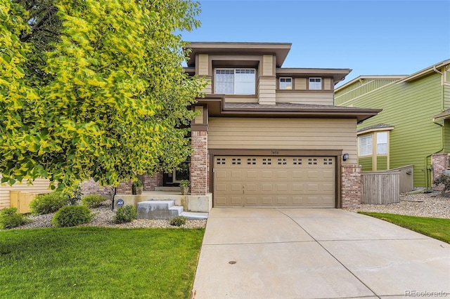 3490 Craftsbury Dr, Highlands Ranch, CO 80126 - prairie-style house with driveway, an attached garage, a front lawn, and brick siding