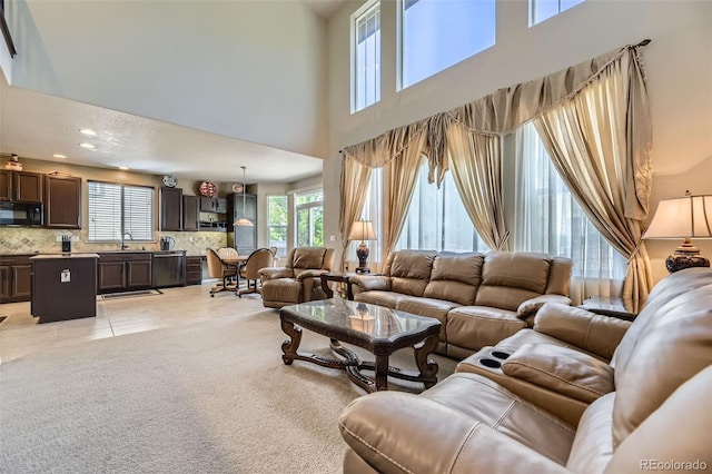 3490 Craftsbury Dr, Highlands Ranch, CO 80126 - living room featuring healthy amount of natural light, a high ceiling, light tile patterned flooring, recessed lighting, and light colored carpet