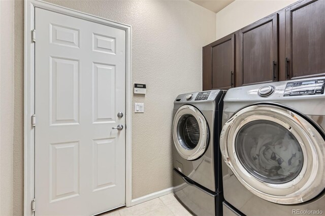 3490 Craftsbury Dr, Highlands Ranch, CO 80126 - laundry room featuring cabinet space, separate washer and dryer, light tile patterned floors, and a textured wall