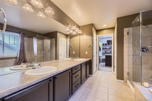 3490 Craftsbury Dr, Highlands Ranch, CO 80126 - bathroom featuring tile patterned flooring, a stall shower, and double vanity