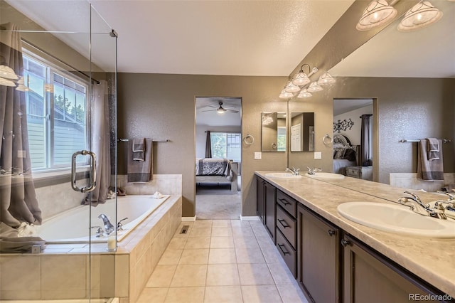 3490 Craftsbury Dr, Highlands Ranch, CO 80126 - ensuite bathroom with plenty of natural light, double vanity, a bath, a textured wall, and a ceiling fan