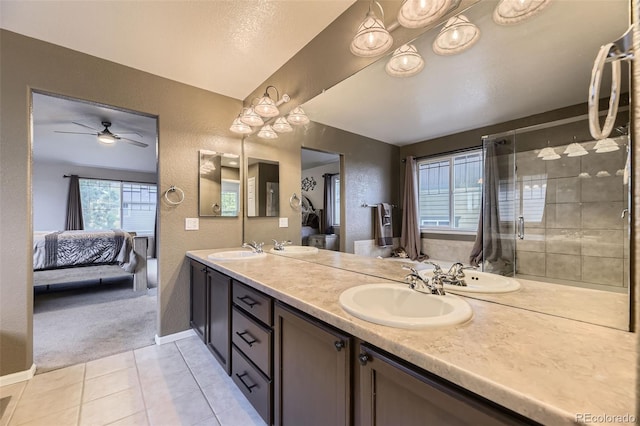 3490 Craftsbury Dr, Highlands Ranch, CO 80126 - ensuite bathroom with a textured wall, tile patterned floors, double vanity, ceiling fan, and a tile shower