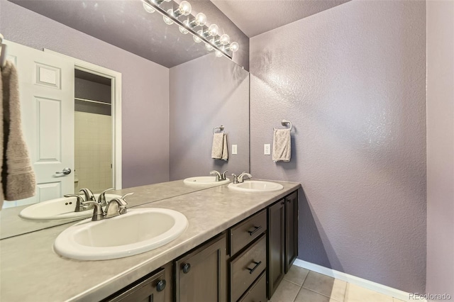 3490 Craftsbury Dr, Highlands Ranch, CO 80126 - full bathroom featuring double vanity, tile patterned flooring, and a textured wall