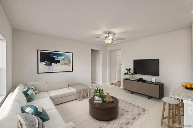 carpeted living room with ceiling fan