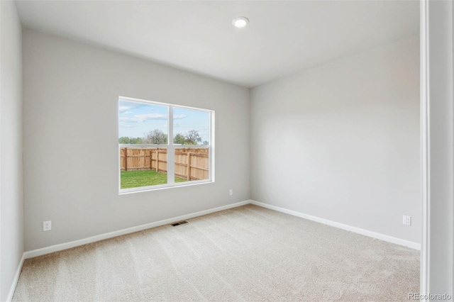 unfurnished room with light colored carpet