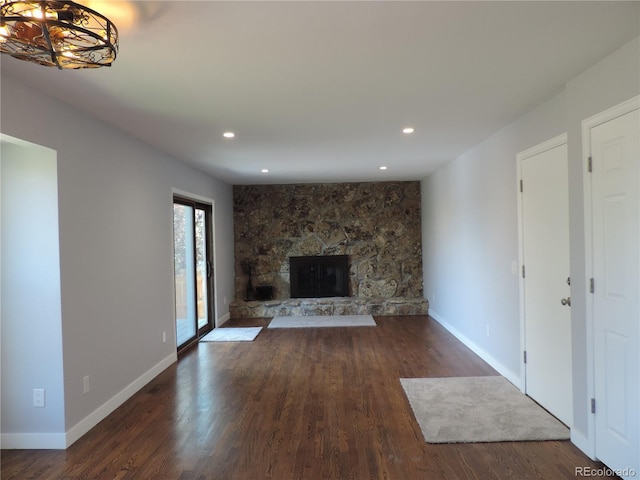 7753 W Plymouth Pl S, Littleton, CO 80128 - unfurnished living room featuring dark wood-style flooring, a fireplace, recessed lighting, and baseboards