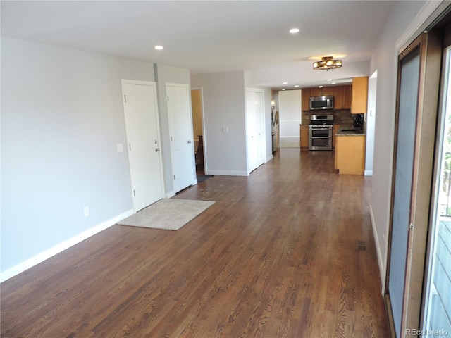 7753 W Plymouth Pl S, Littleton, CO 80128 - unfurnished living room with recessed lighting, dark wood-style floors, and baseboards