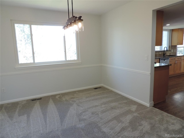 7753 W Plymouth Pl S, Littleton, CO 80128 - unfurnished dining area with carpet flooring, baseboards, and a sink