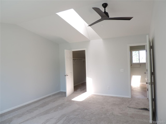 7753 W Plymouth Pl S, Littleton, CO 80128 - unfurnished bedroom featuring vaulted ceiling, carpet floors, a skylight, baseboards, and a ceiling fan