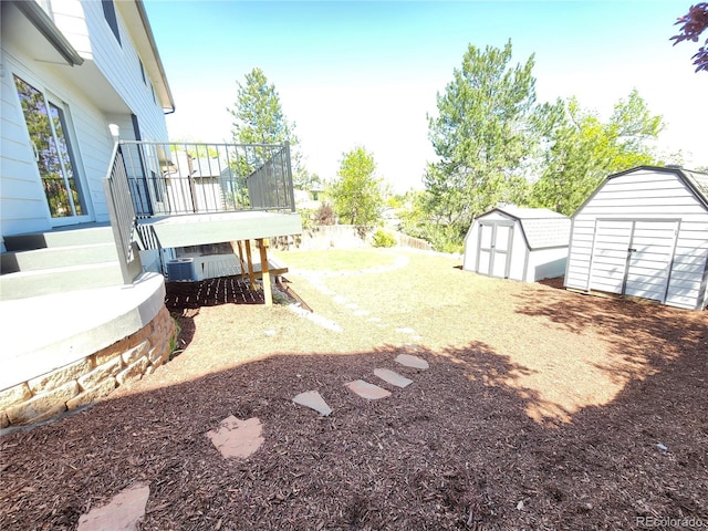 7753 W Plymouth Pl S, Littleton, CO 80128 - view of yard with a shed, an outbuilding, and a wooden deck