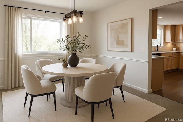 7753 W Plymouth Pl S, Littleton, CO 80128 - dining space with carpet floors and a chandelier