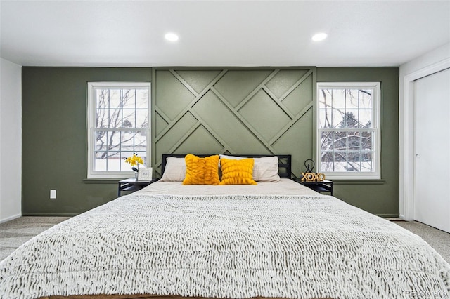 bedroom featuring multiple windows and carpet flooring