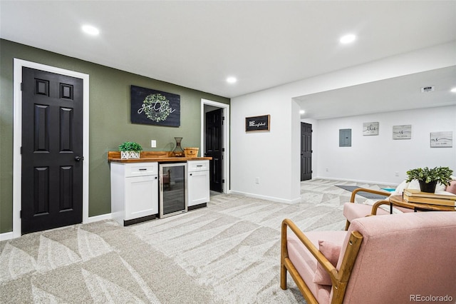 bar with white cabinetry, wine cooler, wooden counters, electric panel, and light carpet