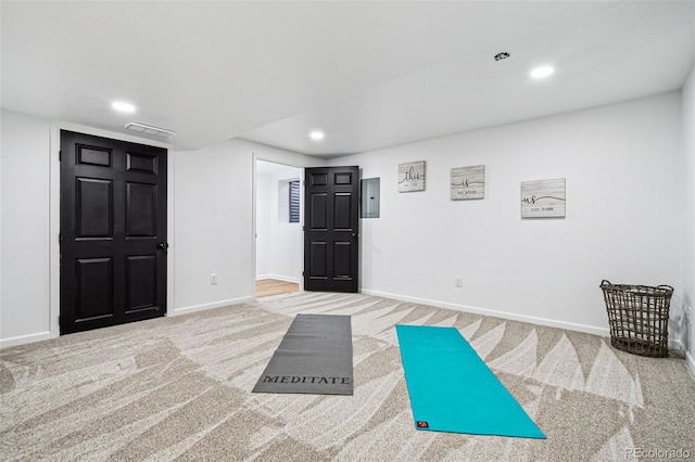 workout area featuring carpet flooring and electric panel