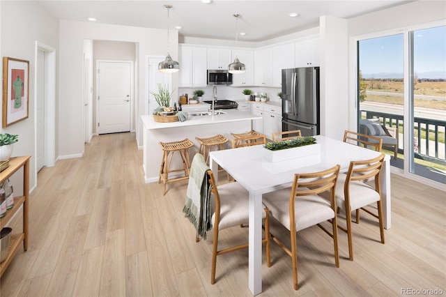 21104 E 63rd Dr, Aurora, CO 80019 - dining area featuring light wood finished floors, recessed lighting, and baseboards