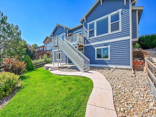 5309 W Hoover Dr, Littleton, CO 80123 - back of property with stairs, a deck, and a lawn