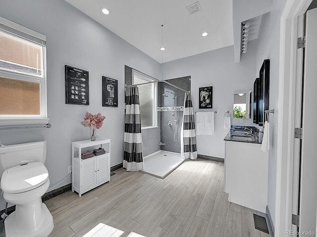 5309 W Hoover Dr, Littleton, CO 80123 - full bathroom featuring wood finished floors, tiled shower, recessed lighting, and vanity