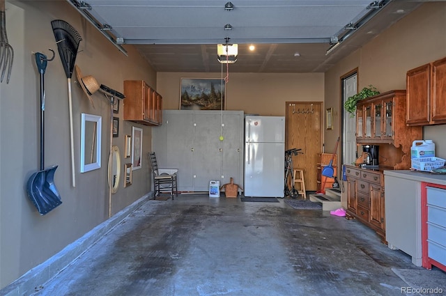 garage with freestanding refrigerator and a garage door opener