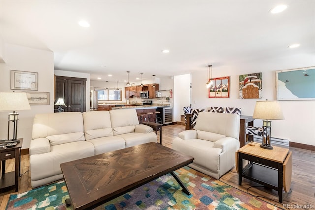 living area with recessed lighting, light wood-type flooring, and baseboards