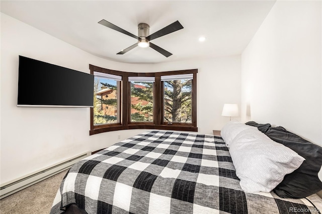 bedroom with ceiling fan and a baseboard radiator