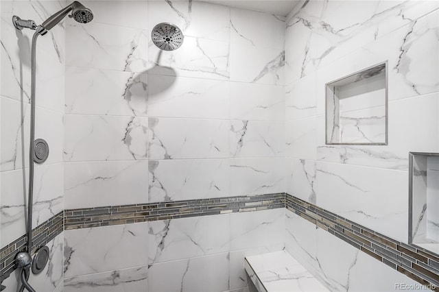 bathroom featuring a tile shower