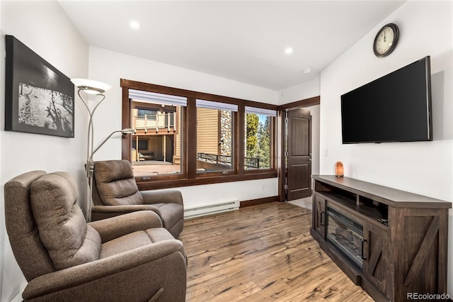 living area with light wood-style flooring, recessed lighting, and baseboard heating