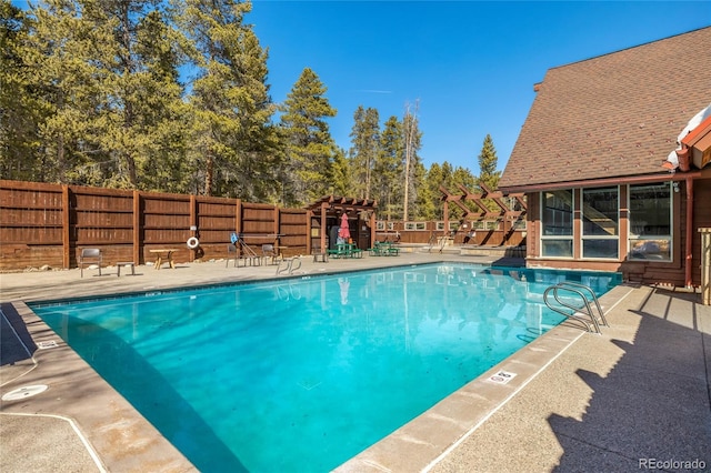 pool with a patio area and a fenced backyard