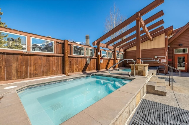 view of pool featuring an in ground hot tub, fence, and a patio area