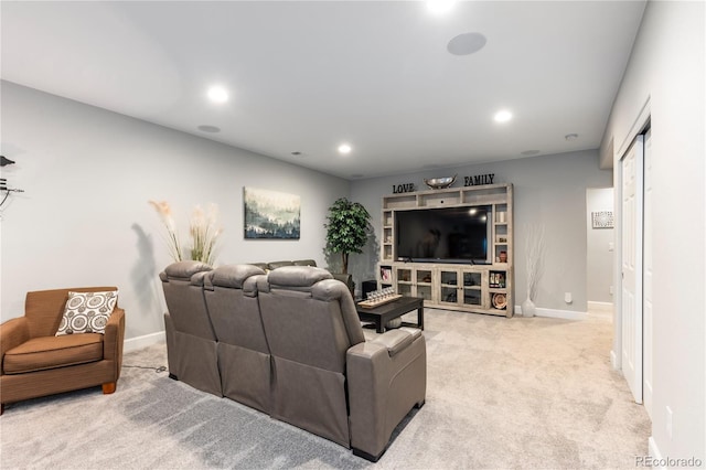 carpeted living area featuring baseboards and recessed lighting