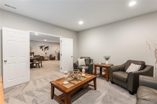 living room featuring light colored carpet, visible vents, and recessed lighting