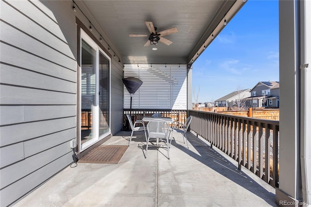 balcony featuring ceiling fan, a residential view, and outdoor dining space