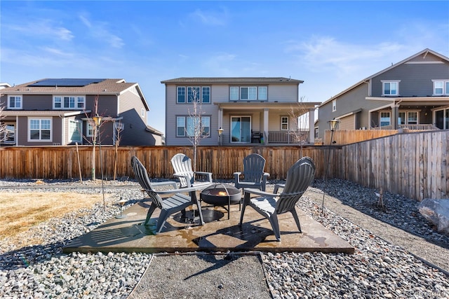 exterior space with an outdoor fire pit and fence