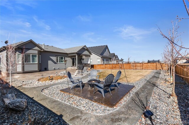 exterior space featuring a fenced backyard, a patio, and a fire pit