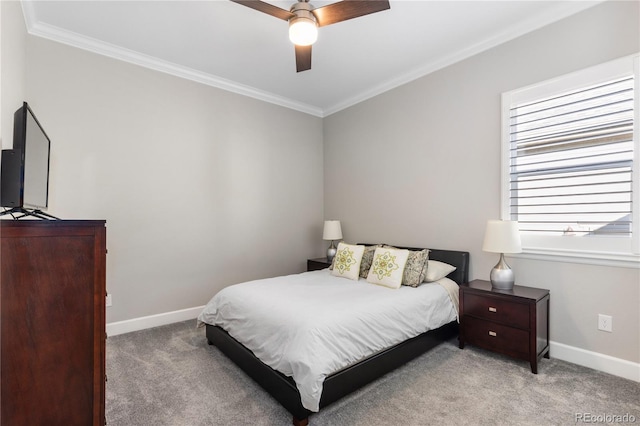 carpeted bedroom with baseboards, ceiling fan, and crown molding