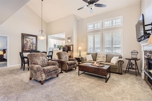 601 Clarendon Loop, Castle Pines, CO 80108 - living room with high vaulted ceiling, carpet floors, a ceiling fan, plenty of natural light, and a fireplace