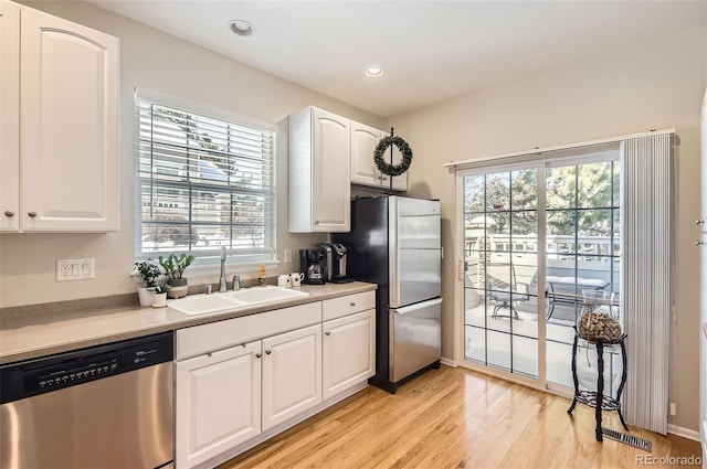 601 Clarendon Loop, Castle Pines, CO 80108 - kitchen with stainless steel appliances, light wood-style floors, healthy amount of natural light, white cabinets, and recessed lighting