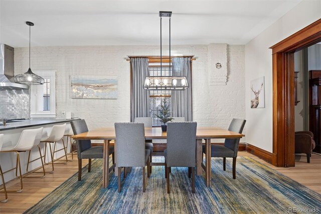 1554 N Pennsylvania St, Denver, CO 80203 - dining area featuring a wealth of natural light, baseboards, and wood finished floors