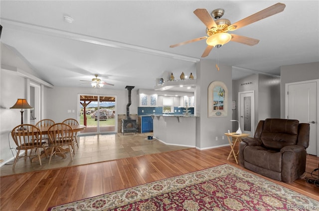 235 Blazing Saddle Trl, Cotopaxi, CO 81223 - living area featuring ceiling fan, lofted ceiling, wood finished floors, a wood stove, and baseboards