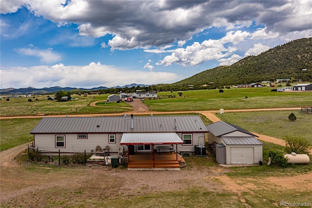235 Blazing Saddle Trl, Cotopaxi, CO 81223 - rear view of house featuring a mountain view, metal roof, an outbuilding, and central air condition unit