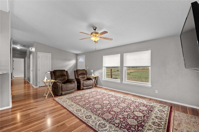 235 Blazing Saddle Trl, Cotopaxi, CO 81223 - living room with ceiling fan, wood finished floors, baseboards, vaulted ceiling, and a textured ceiling