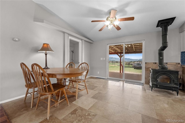 235 Blazing Saddle Trl, Cotopaxi, CO 81223 - dining room with a wood stove, a ceiling fan, vaulted ceiling, and baseboards