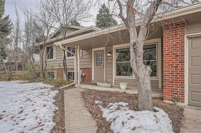 view of snow covered property entrance