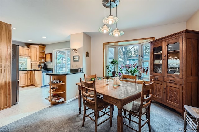 carpeted dining space featuring plenty of natural light